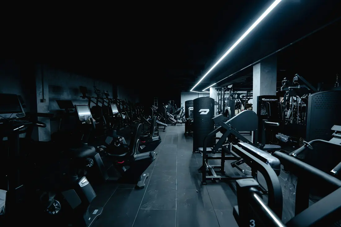 A gym floor lined with strength machines