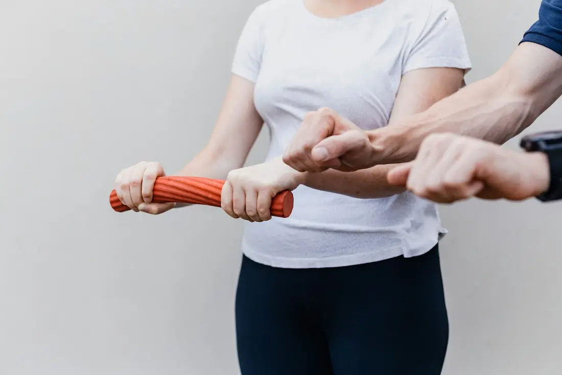 A physical therapist guiding a patient through a resistance exercise