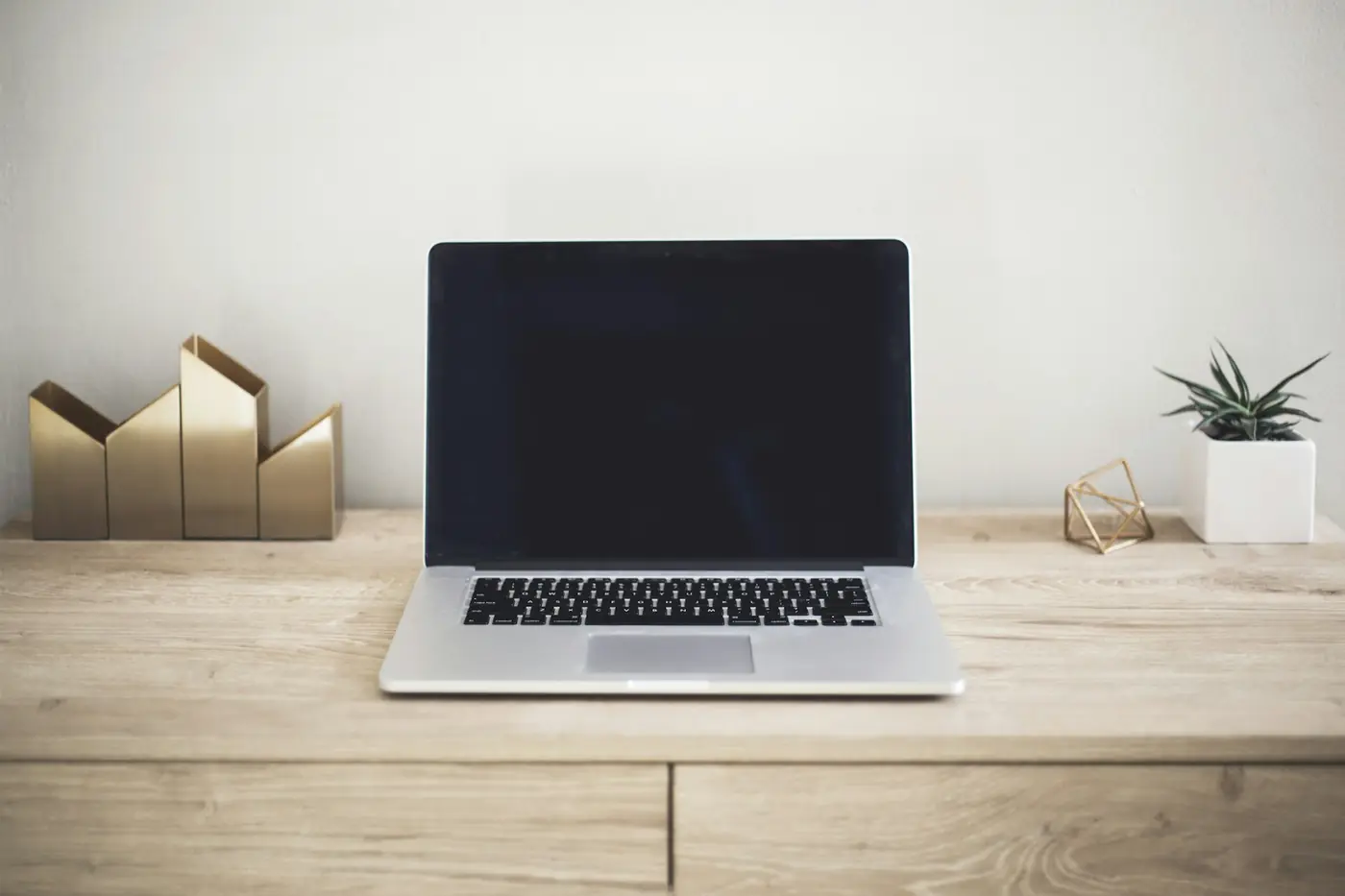 A laptop on a tidy wooden desk